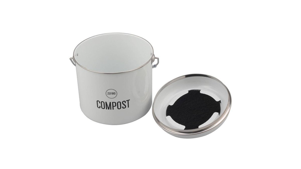 Reusable charcoal filter composter on a kitchen counter beside vegetable scraps